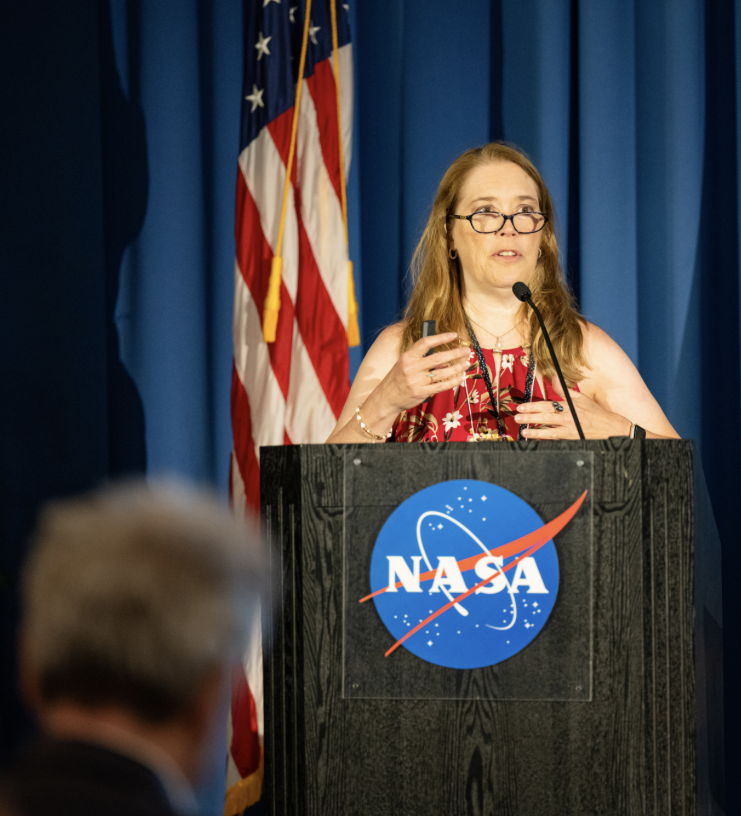 NASA Conjunction Assessment Program Officer Lauri Newman speaks at the 2024 NASA SmallSat Learning from Experience, Achievements, and Resolution, Navigation LEARN forum in the ballroom of Building 3 at NASA Research Park.